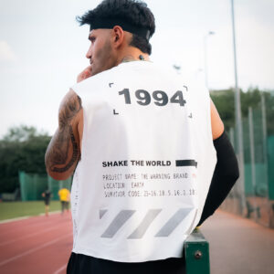 Man in a sleeveless white shirt with '1994' printed on the back.