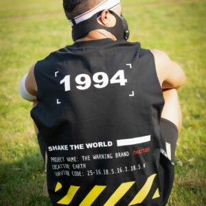 Person wearing a black sleeveless shirt with '1994' on the back.